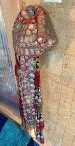 lot 25 image: Highly Decorated Turkoman Headdress wSilver Silk Dangles