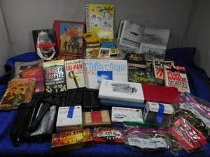 lot 258 image: Shell casings, Military and hunting books, 3 militarypolice berlin ammo pouches, paper airplane kit