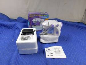 lot 278 image: New mini 2 speed Sewing Machine with adaptor, foot pedal, thread, threader, bobbins and instructions