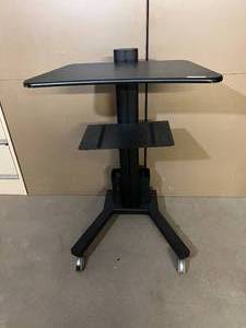 lot 7 image: MSRP $450 Two Tier Mobile Standing Desk - Rolls Room To Room - Office To Office with Storage Organizer Basket In Back - Great Condition