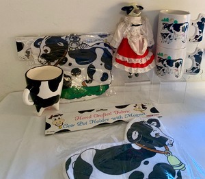 lot 203 image: Collection of Cow Themed Coffee Cups, Salt and Pepper Shakers, Hot Pads, Cow Doll and More