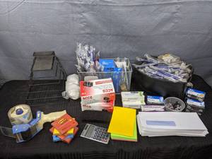 A Variety of Office Supplies Including Tape, Post Its, Pens, Paper Clips and More