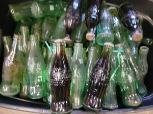 lot 65 image: A storage bin full of Old Glass Coca-Cola Bottles.