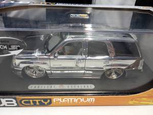 lot 151 image: Dub City Platinum Cadillac Escalade 118th Scale Die Cast Truck