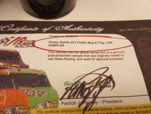 lot 556 image: Sample Mugs and Can Koosie from Joe Gibbs Racing With COA