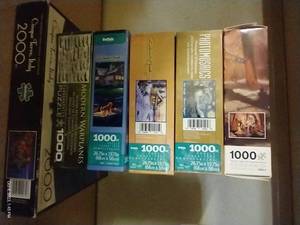 lot 26 image: (6) 1,000 Piece Puzzles & (1) 2,000 Piece Puzzle - New In Box