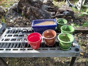 lot 126 image: (5) Small Round Pots, (1) New Rectangular Clay Pot, And Misc. Garden Decor