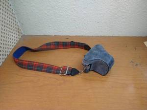 lot 181 image: Vintage Canon SLR With Strap, Case, 50mm Lens, And Lens Filter