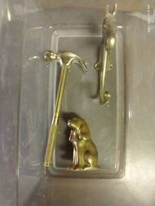 lot 239 image: Brass Horse Head Coat Hanger, Dog Figurine, And Hammer