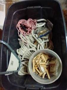 lot 400 image: Tote Of Rope, Heavy Duty Clothes Pins, Multi-Purpose Hanger, And Grommet Installation Kit