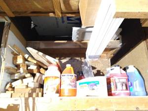 lot 558 image: Top Shelf Full Of Scrap Wood, Chicago Electric Vibratory Bowl, Walnut Shells, Windshield Fluid, And Other Misc.
