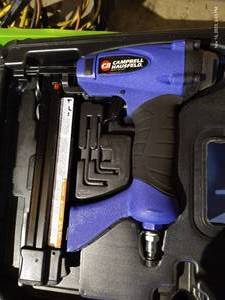 lot 580 image: Pneumatic Staple Gun, Caulk Gun, And Other Misc. Tools In Crate