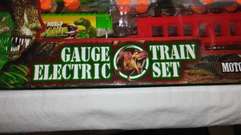 lot 630 image: Battery Operated Dinosaur Toy Train with Tracks