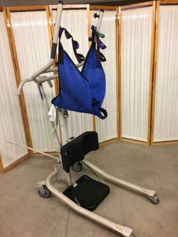 lot 11 image: MSRP $1200&nbspInvacare Get-U-Up Hydraulic Sit To Stand-Up Patient Lift 350 lb. Weight Capacity With Sling - Like New Condition&nbsp See Youtube For How This Great Lift Works