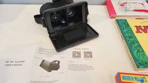 lot 211 image: Books, magazines, Warren Miller Ski videos  and virtual reality goggles