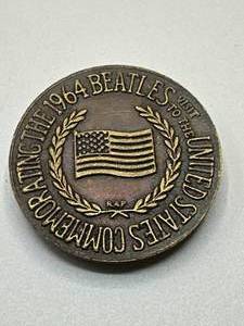 lot 16 image: The Beatles Brass Token