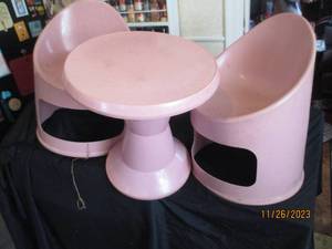lot 36 image: Vintage pink plastic stackable table and (2) chair set (one chair is cracked at the base on the back side, does not affect functionality)