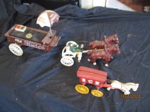 lot 46 image: Vintage cast iron horse drawn fruit wagon and smaller scale cast iron horse drawn Ice cooler wagon