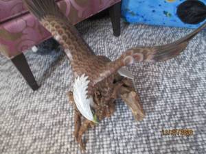 lot 34 image: Hand carved and painted Eagle about to swoop off his driftwood perch. measures approximately 132120