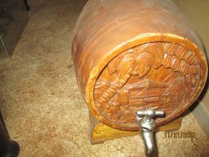 lot 31 image: Vintage Wood Keg and stand. Intricate carvings on the face of the barrel with the tap. measures approximately 10.5812.5