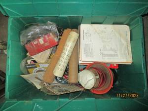 lot 25 image: Assortment of vintage car manuals and parts, blow-gun, extension cord, soldering iron plus lots of other vintage goodies all in a Green clamshell closing tote
