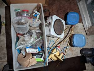 lot 4 image: Long Tupperware style container loaded with a huge Assortment of construction hardware and other supplies