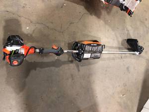 lot 14 image: ECHO 21.2 cc Gas 2-Stroke Straight Shaft String Trimmer   Customer Returns See Pictures
