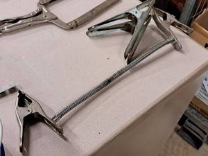 lot 256 image: (2) Metal Clamps and (1) Dual Clamp with Flex Line