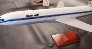 lot 22 image: Iran Air Die Cast Metal Plane on a Wood and Metal Stand, Plane Measures 18.5-inches Long, 13-inches Wide Wing Tip to Wing Tip, and 8-inches from the