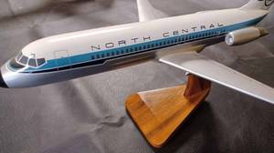 lot 23 image: North Central Airplane on a Wood Stand, Plane Measures 15-inches Long, 12-inches Wide Wing Tip to Wing Tip, and 7.5-inches Tall from the Bottom of