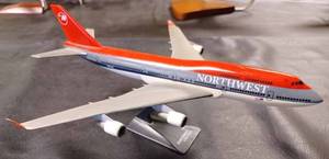 lot 25 image: Northwest Airlines Plastic Airplane on a Plastic Stand, Plane Measures 11-inches Long, 10.25-inches Wide Wing Tip to Wing Tip, and 5-inches from the