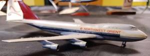 lot 29 image: Northwest Orient Die Cast Metal Airplane - No Stand, Has Folding Landing Gear, Plane Measures 9.5-inches Long, 8.5-inches Wide Wing Tip to Wing Tip