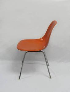 lot 10 image: A Pop of Color The Iconic Herman Miller Eames Orange Shell Chair