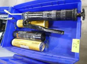 Two bins of grease guns