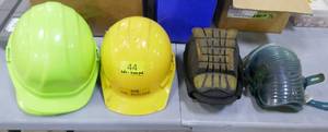3 hard hats and 2 sets of knee pads