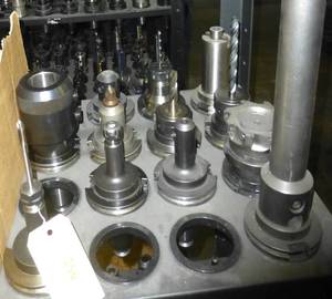 Thirteen CAT50 tool holders, collets, tooling