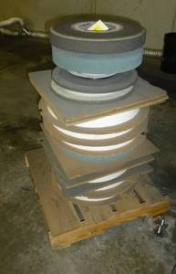 Stack of new, 14 inch wheel, 5 inch hub surface grinding wheels, most are 2 in thick