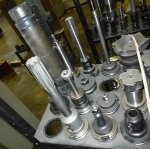 Thirteen CAT50 tool holders, collets, tooling