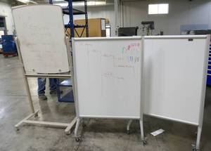 Three rolling white boards
