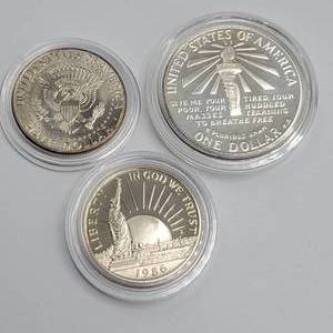 lot 77 image: 1986 Ellis Island Dollar (90% Silver), 1986 Clad Half Dollar & 2008-P Kemmedy Half Dollar
