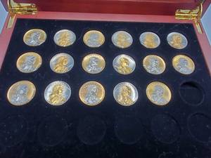 lot 36 image: 17 Platinum & Gold Highlighted Sacagawea Dollars in Wood Display Case