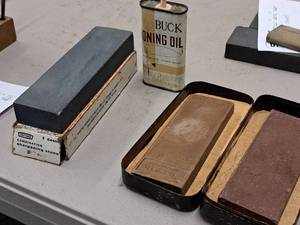 lot 643 image: (3) Assorted Sharpening Stones and (1) Partial Can of Buck Honing Oil