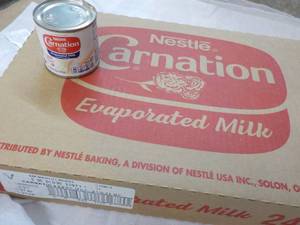 lot 122 image: 24 ct 5 oz Cans Nestles Carnation Evaporated Milk - best date 08312023