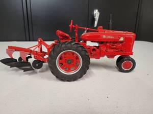 lot 83 image: McCormick Farmall Super M-TA Tractor with a 2 bottom Plow 116 Scale