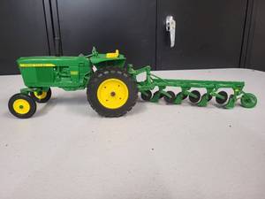 lot 90 image: John Deere Model 3020 with a  4 bottom plow 116 Scale