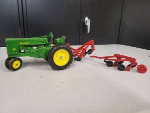 lot 134 image: John Deere Model 70 Tractor with Broken 4 bottom plow 116 Scale