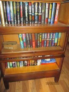 All books and novels in cabinet by authors such as John Sandford, John Grisham, James Patterson and more (does not include cabinet)