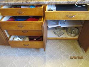 Content of 5-drawer and 2-cabinet built-in to include glass bakeware, pan and storage lids, wine toppers, hand towels and other supplies