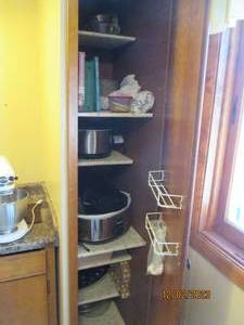 Content of right side kitchen pantry to Include Cookbooks, Crock pots, misc serving pieces and more