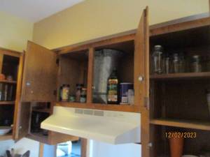 Content of upper cupboards above stove including drinkware, seasonings and other Misc kitchen supplies